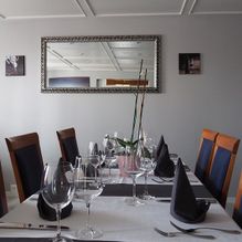 Zwei gedeckte Tische mit Weingläsern bei Rössli Restaurant